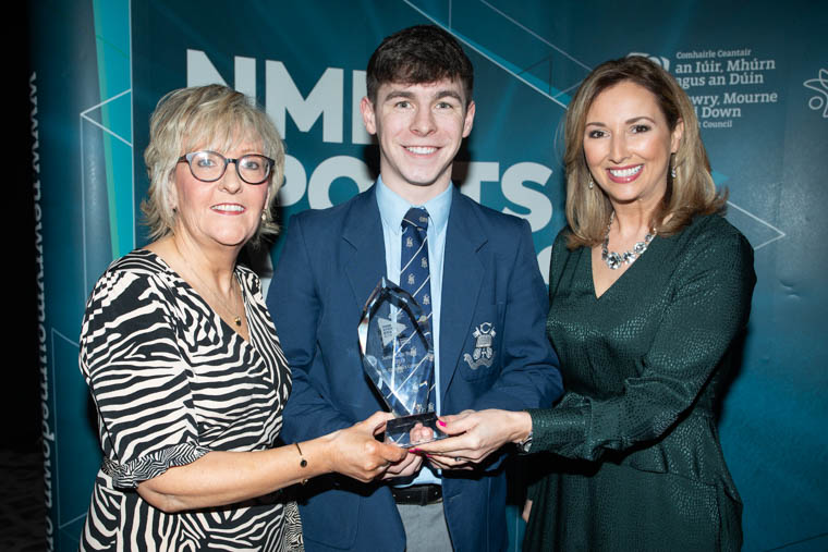 Oonagh Murray, Chairperson of the Sports Association Newry, Down and South Armagh presents the Junior Club Team of the Year 2019 award to Dan McCarthy, St Colman’s College, Gaelic Football Club. Included is awards host Claire McCollum.