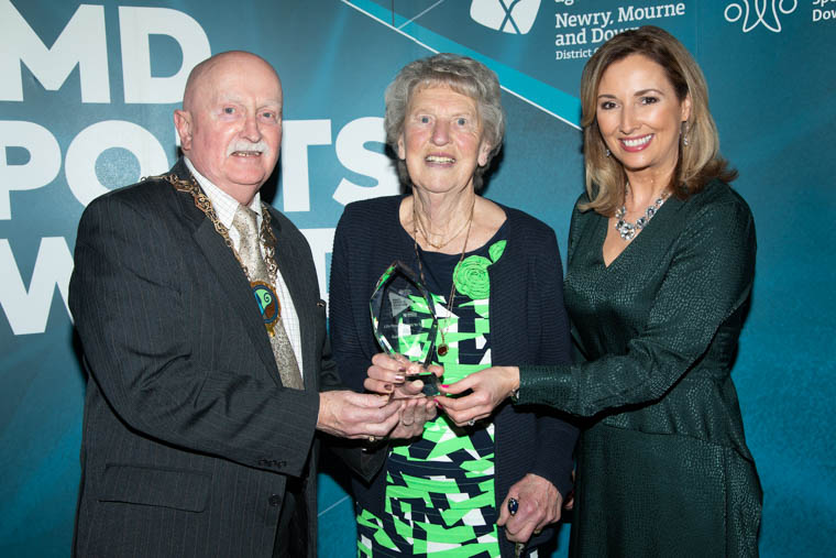 Newry, Mourne and Down District Council Chairperson, Councillor Charlie Casey presents the Life-Time Services to Sport 2019 award to Kathleen Heenan, Newcastle Harbour Swimmers. Included is awards host Claire McCollum.