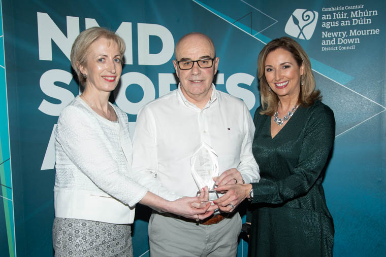 Jane Gribben presents the Sport Volunteer of the Year Award 2019 to Pat McGivern, Midway United Football Club. Included is awards host Claire McCollum.
