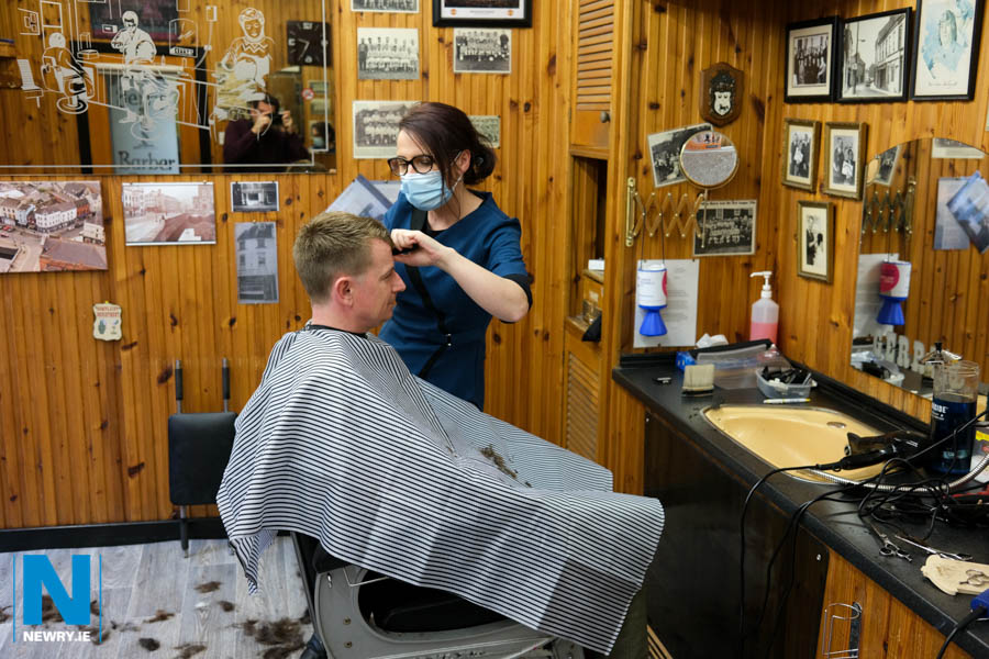 It's back to work for Eva Devine, Gerry's Barber Shop, Newry with Sean McAlinden in the hot seat. Photograph: Columba O'Hare/ Newry.ie