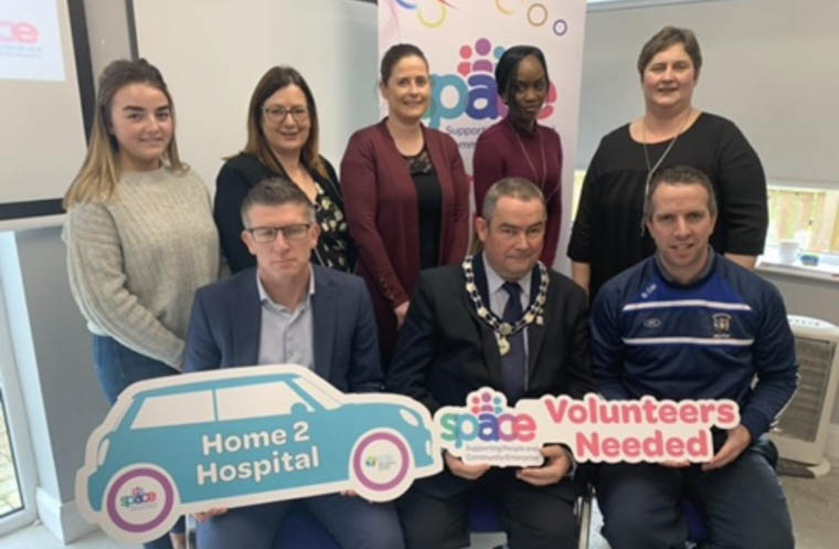 Pictured at the launch of the Slieve Gullion Home 2 Hospital Scheme are back from left: Megan Murdock, SPACE; Allison Slater, SPACE; Cllr Oonagh Magennis, Taücher McDonald, Slieve Gullion DEA Co-Ordinator and Kate Quinn, Lislea Community Centre. Front: Eoin Devlin, Asst Director of Health and Wellbeing, Newry, Mourne and Down District Council; Terry Andrews, Deputy Chair, Newry, Mourne and Down District Council and Cllr Barra Ó Muirí . Pictured at the launch of the Slieve Gullion Home 2 Hospital Scheme are back from left: Megan Murdock, SPACE; Allison Slater, SPACE; Cllr Oonagh Magennis, Taücher McDonald, Slieve Gullion DEA Co-Ordinator and Kate Quinn, Lislea Community Centre. Front: Eoin Devlin, Asst Director of Health and Wellbeing, Newry, Mourne and Down District Council; Terry Andrews, Deputy Chair, Newry, Mourne and Down District Council and Cllr Barra Ó Muirí .