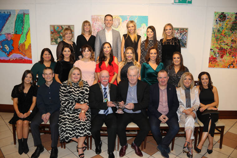 Teaching staff from St Patrick's Primary School, The Meadow, Newry, attend a Council Reception hosted by the Chairperson of Newry, Mourne and Down District Council, Councillor Charlie Casey in Sean Hollywood Arts Centre to mark the 60th Anniversary of the school. An inscribed crystal bowl was presented to Principal Ciaran Mackin by the Chairperson. Chairperson Hosts 60th Anniversary Celebrations for St. Patrick’s Primary School, Newry The Chairperson of Newry, Mourne and Down District Council, Councillor Charlie Casey has held a reception to mark the 60th anniversary of Saint Patrick’s Primary School, The Meadow, Newry. Speaking at the reception in Newry Arts Centre on 13 December 2019, Councillor Casey said, “I am delighted to host the teachers and Board of Governors of St. Patrick’s Primary School tonight to celebrate 60 years of the school–what a milestone! “Whilst tonight is primarily a celebration, we should also reflect on all those pupils and staff who are sadly no longer with us. “It is impossible to fully express the immeasurable contribution that this school has made to the fabric of life in Newry over 60 years, not forgetting of course the Nursery and their outstanding gift to pre-school education since its birth 20 years ago. “Thousands of boys and girls have enjoyed the wide-ranging curriculum menu provided by this school over the last 60 years. Throughout our troubled past and times of conflict, Saint Patrick’s provided a haven or sanctuary as the boys tried to escape from the Troubles that were raging right across the North. “In my role as a governor and formerly a member of the local Education Authority, I am only too aware of the pressures that schools face daily, and at times, we can get lost in the educational speak surrounding learning outcomes, high quality teaching and learning.” Councillor also paid tribute to the school’s dedication to Shared Education and the impact made by Principal Mr Ciarán Mackin.
“Shared Education is a welcome new initiative within education but again it should come as no surprise that Saint Patrick’s and their sister school, Windsor Hill, have been actively engaging in shared activities over the past 10 years, so much so that it can be said that it is the model on which Shared Education has been built,” he said. “Mr Ciarán Mackin became Saint Patrick’s fourth principal upon his appointment in October 2009, overseeing another decade of high quality education in The Meadow. Every pupil is encouraged to live out the school motto of ‘Dream, Believe, Achieve’, whilst all staff strive to make Saint Patrick’s a “place of love, learning and laughter”. On a personal note, I would like to pay tribute to Ciarán, who I have known for many years. Not only is he an excellent teacher, he is a role model and a friend to all his teaching staff. His personal style of outstanding leadership has inspired staff and students. Under Ciaran’s leadership the school has gone through tremendous positive change. He practises what he preaches; he is proud of his school and he doesn’t just value the students but the community as a whole. “As we close this chapter in the history of this great school, I have every confidence that the next chapter will continue to be equally as rewarding and successful.”