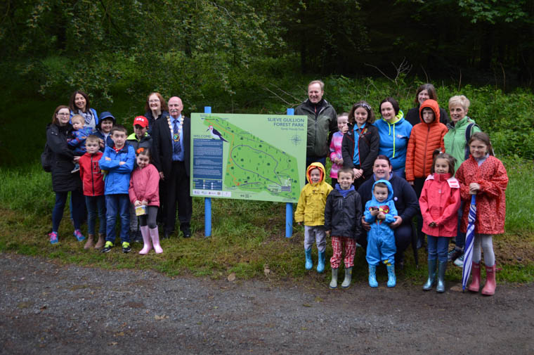 Newry, Mourne and Down District Council Chairperson, Councillor Charlie Casey launches the new Sensory Trail at Slieve Gullion Forest Park accompanied by Ring of Gullion Landscape Partnership Chairperson, Des Murphy, RoGLP staff, Brilliant Trails representatives who designed and installed the trail and families from Autism Families Newry.