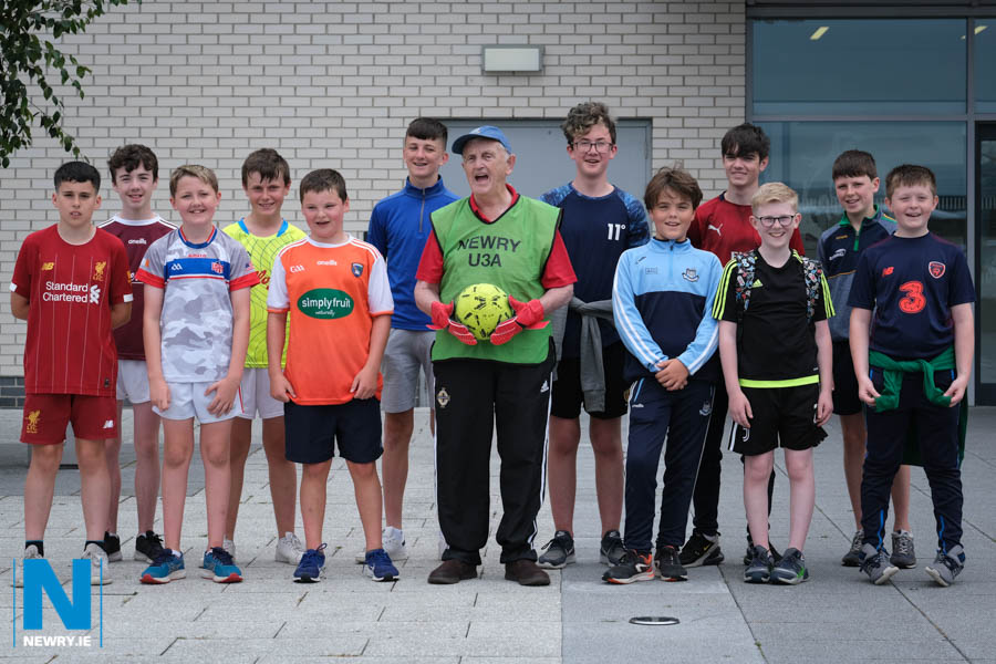 Young at heart goalie Joseph Alphonsus Morgan (91) with some just slightly younger footballer who were taking part in a TBUC (Together Building United Communities) sporting shared education partnership with children from St Paul's High School, Newtownhamilton High School and Newry High.  Photograph: Columba O'Hare/ Newry.ie