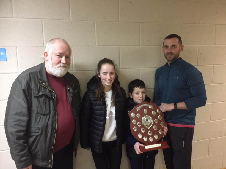 Paudie Tavey winner of this year’s “Richard Hughes” memorial shield is congratulated by Kevin Hughes representing the Hughes family. Also included is Paudie’s sister Hannah and Craobh Rua committee member Peter O’Hanlon.