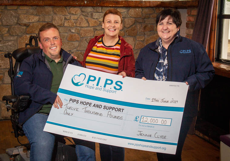 Jennie Clyde (Middle) presenting the cheque for the exceptional £12,000 to PIPS Hope and Support’s Padraig Harte (Left) and Roisin Martin (Right) Jennie Clyde (Middle) presenting the cheque for the exceptional £12,000 to PIPS Hope and Support’s Padraig Harte (Left) and Roisin Martin (Right)