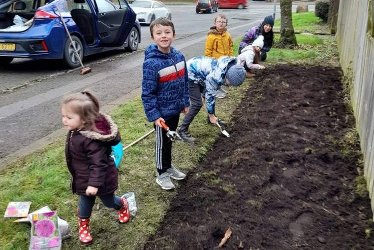 Children planting bulbs in preparation for Spring.