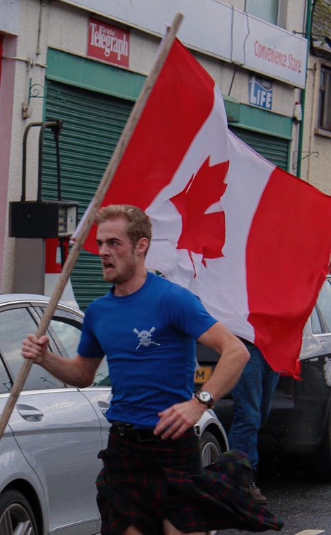 Running with a Canadian flag, his fathers home Country. Running with a Canadian flag, his fathers home Country.