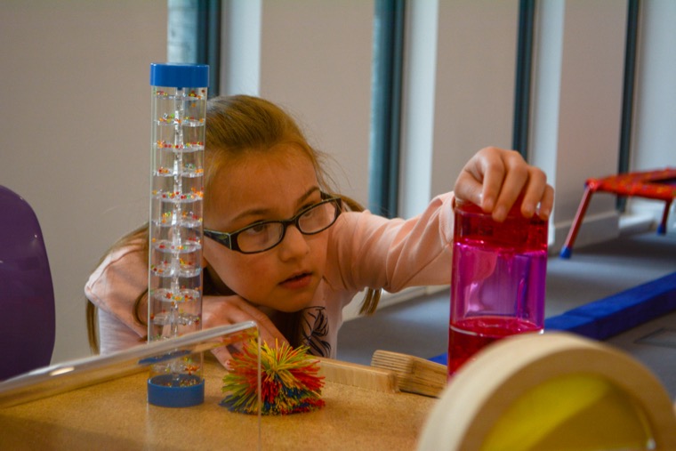 A child supported by Caudwell Children using sensory items.