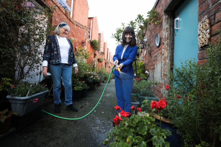 Infrastructure Minister Nichola Mallon with local resident Brigid Loughran during a visit to Ardmore/Rossmore Avenues alleyway in Belfast.