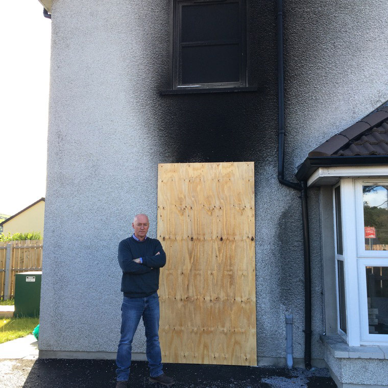 Cllr Murphy at the smoke damaged Bessbrook property.