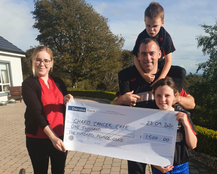 Frank McCabe and family make a presentation of £1500 to Charis. Frank McCabe and family make a presentation of £1500 to Charis.