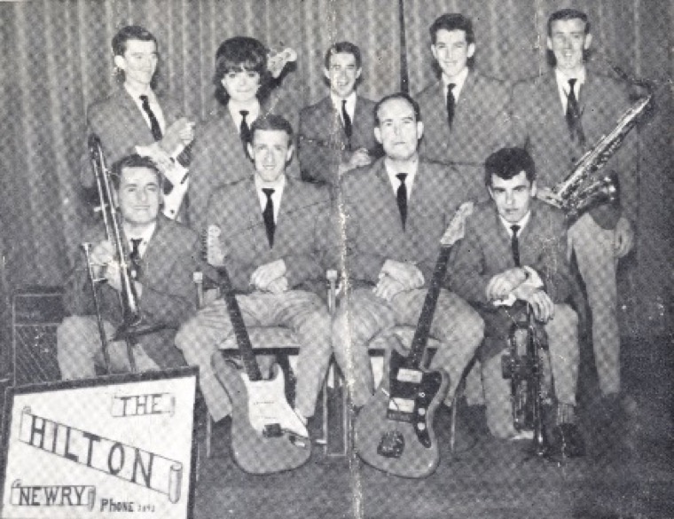 The Hilton showband. In no particular order: Hughie Kimmons, Luke Burke, Gerry Black, Ricky McVeigh, John Hughes, Tommy Tohill, Patricia Gratton and Mickey Doran on his famous 1956 Fender Stratocaster, an instrument which former Hilltown INF performer and blues legend Rory Gallagher was said to have coveted. Newry and Mourne Museum Collection The Hilton showband. In no particular order: Hughie Kimmons, Luke Burke, Gerry Black, Ricky McVeigh, John Hughes, Tommy Tohill, Patricia Gratton and Mickey Doran on his famous 1956 Fender Stratocaster, an instrument which former Hilltown INF performer and blues legend Rory Gallagher was said to have coveted. Newry and Mourne Museum Collection