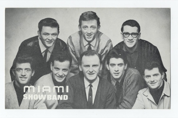 Publicity postcard from the 1960s promoting the Miami Showband. featuring Joe Tyrell, Clem Quinn, Dickie Rock, Martin Phelan, Tommy O'Rourke, Tony Bogan, Murty Quinn and Denis Murray. The Miami Showband was attacked during The Troubles at Bushkill, near Newry, in July Publicity postcard from the 1960s promoting the Miami Showband. featuring Joe Tyrell, Clem Quinn, Dickie Rock, Martin Phelan, Tommy O'Rourke, Tony Bogan, Murty Quinn and Denis Murray. The Miami Showband was attacked during The Troubles at Bushkill, near Newry, in July