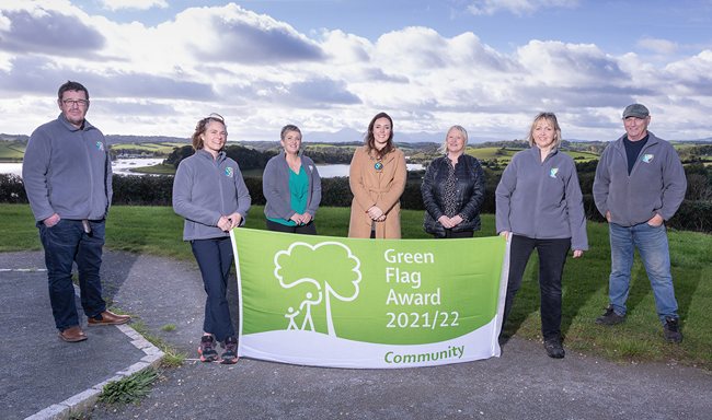 Newry, Mourne and Down District Council Chairperson, Councillor Cathy Mason unveiling the Green Flag Award at Delamont Country Park with park rangers and staff members (from left) Kenny Smith, Amy Arlow, Barbara Fleming-Ovens, Una Savage, Judith O'Neill and Shane Hogg.