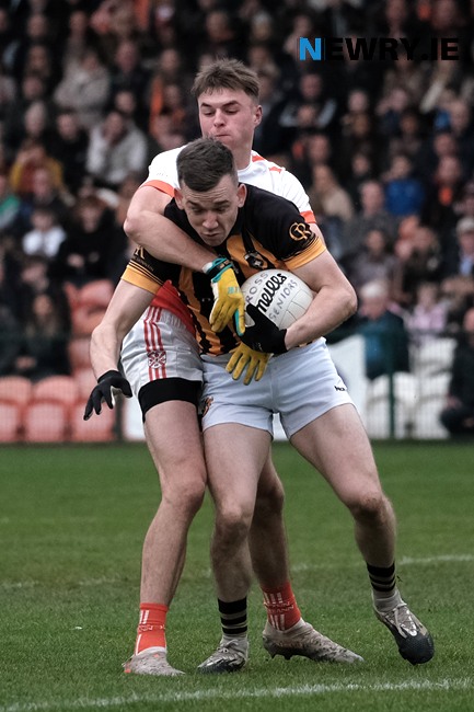 Crossmaglen's Paul Hughes under pressure from Clann Éireann's Daniel Magee at the Athletic Grounds. Crossmaglen's Paul Hughes under pressure from Clann Éireann's Daniel Magee at the Athletic Grounds.