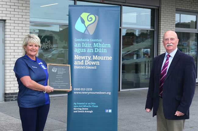 Cllr Charlie Casey, Chair of the Newry DEA forum, with Dorothy Taylor of Newry City AFC who received a slate plaque for her club’s support during the food parcel scheme run by Newry Mourne and Down District Council during the Covid-19 epidemic. 