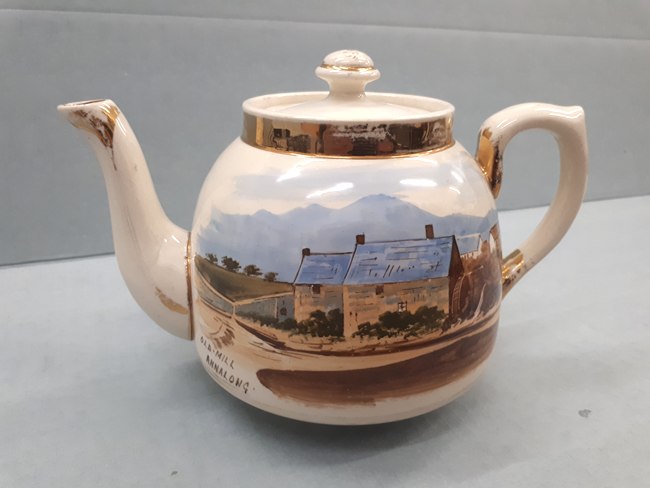 A teapot from the first half of the 20th century depicting Annalong Corn Mill. Newry and Mourne Museum Collection