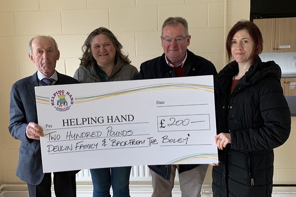 Tommy Devlin, Sinead Rice McAleavey and Adiena Devlin present a cheque for £200 to Nigel Kearney from Helping Hand.