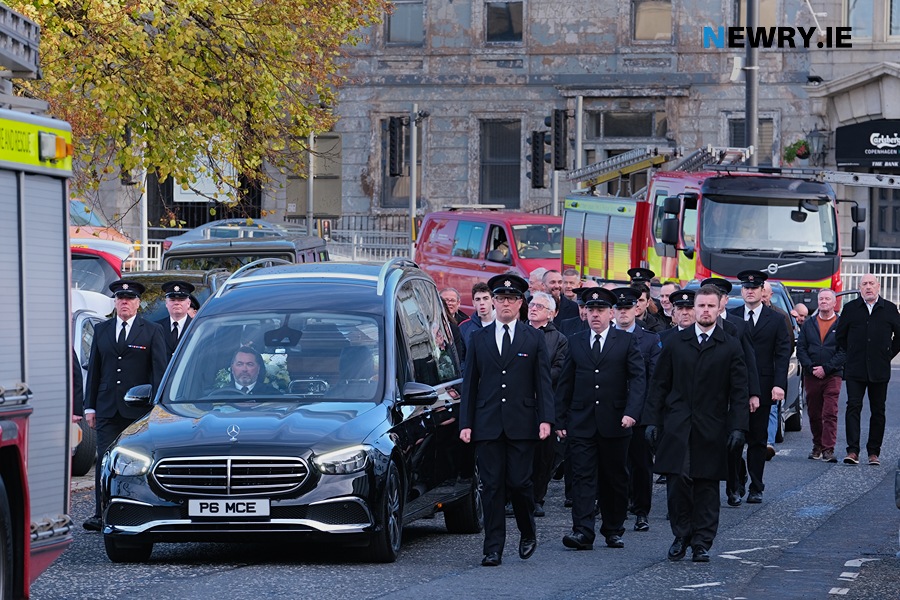 Colleagues from NIFRS flank the hearse.