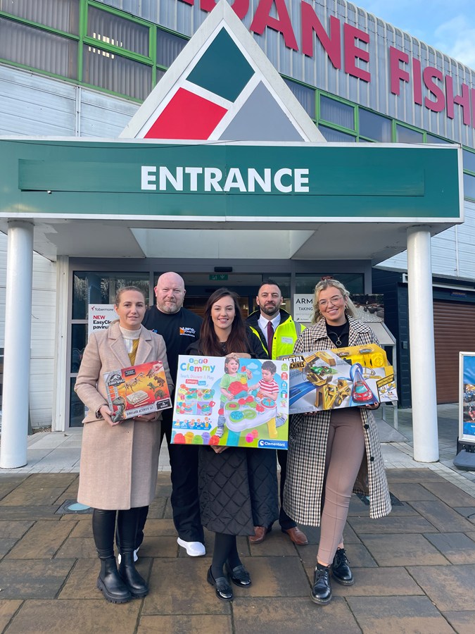 Pictured with some of the donations are back from left: Ernie Campbell, local fundraiser, Colin Johnston, Health and Safety / Facilities Manager at Haldane Fisher. Front: Aisling Fitzmaurice, Sarah Kelsey, and Hannah McCann from the Children’s Disability Team and Southern Health and Social Care Trust.