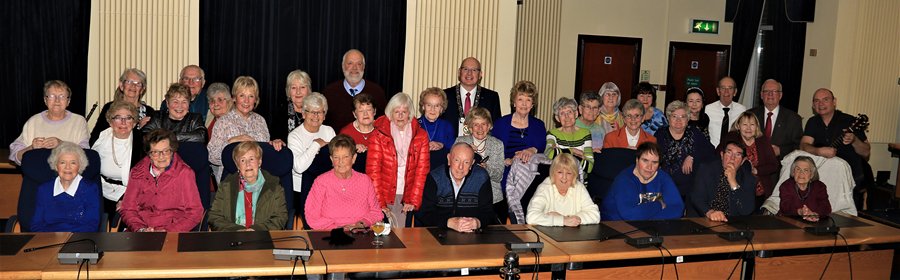 Newry, Mourne and Down District Council Chairperson, Councillor Michael Savage with members of the Warrenpoint Friendship Club in the Council Chamber, Monaghan Row.