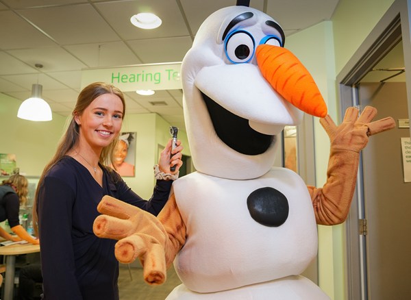 Olaf gets his hearing checked by Ella Hodben at Specsavers Newry during their recent 25th birthday celebrations.
