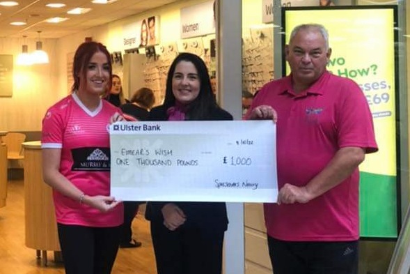 Maria Morgan (centre) store manager of Specsavers Newry, presents Seán Smyth and Jane Taylor Grieves from Eimear’s Wish with a cheque for £1,000, raised by the team in store.
