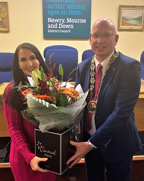 Newry, Mourne and Down District Council Chairperson, Councillor Michael Savage presents Fiona Flynn Director of Flynn Performing Arts, Newry with a bouquet of flowers to congratulate her on the success of her three students Sophie, Clare and Niamh in the recent Junior Eurovision Éire 2022 competition.