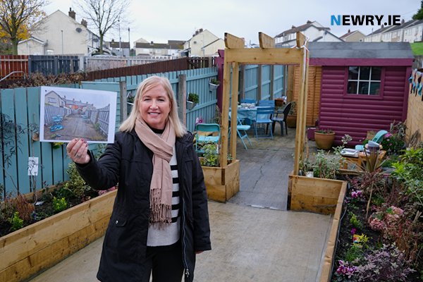 Roisin Murray Gibbons displays a before photograph of the garden. 