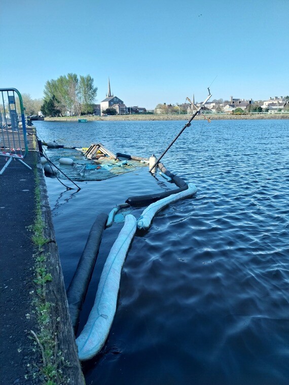 Only the top of the mast is seen of the sunken boat at the Albert Basin.