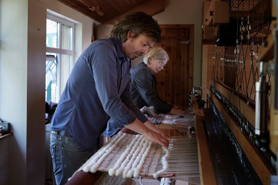 Karen and Mario weaving wall hangings.