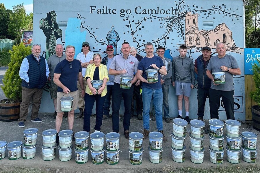 Chris Bagnall and David Somerville, Haldane Fisher present the paint to members of Camlough Men's Shed.