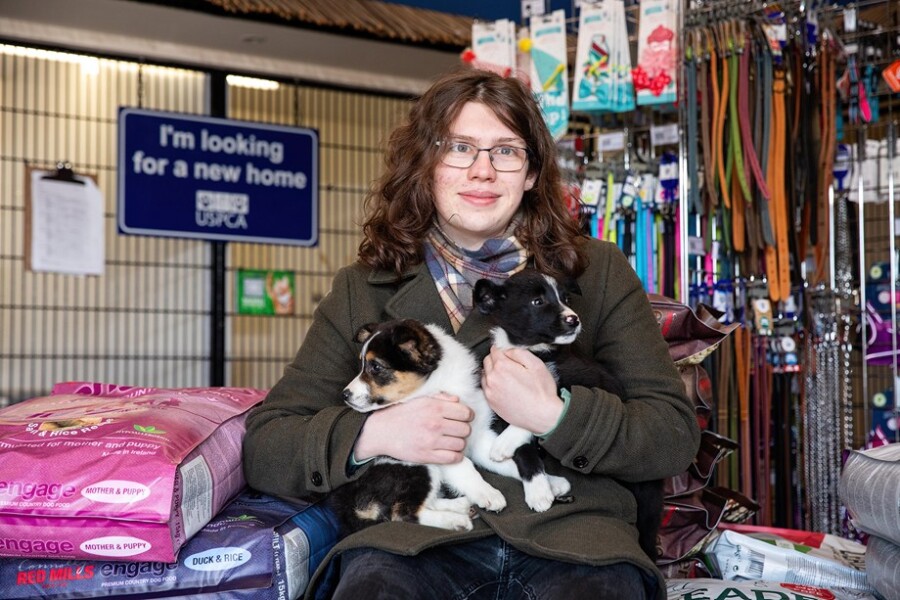 Dara McAnulty holding a couple of rescue puppies.
