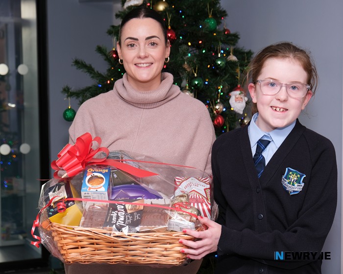 The second prize Christmas Hamper in the Christmas Draw at St Malachy's PS was won by Angie. St Malachy's PS Teacher Danielle Digney presents the hamper to seller of the winning ticket Annie Mae Carville. Photograph: Columba O'Hare/ Newry.ie