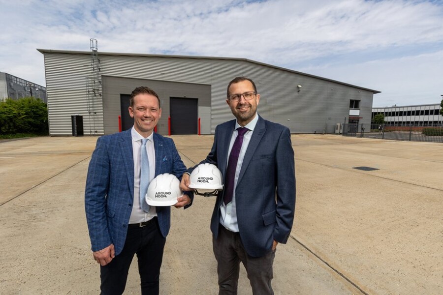 Gareth Chambers, CEO of Around Noon, and Wesley Jenkins, Operations Director, announce the investment in the company’s sixth manufacturing site. They are pictured at the new site at Slough Trading Estate which will undergo major renovation.   PRESS RELEASE 14th August 2023   AROUND NOON TO OPEN SIXTH UK MANUFACTURING SITE TO FACILITATE STRONG ORGANIC GROWTH Contract wins in travel, foodservice and coffee sectors help propel firm’s ongoing rapid expansion   Around Noon, the fast-growing food-to-go (FTG) manufacturer, is set to open a major new factory at Slough Trading Estate near London and will create up to 200 new jobs as part of an investment plan announced today.   The company, which recently acquired the North London-based Soho Sandwich Company, has also enjoyed strong organic growth in recent times, including securing a series of large contracts in the travel, foodservice and coffee sectors.   As a result of this organic growth and to facilitate future expansion, the company has acquired a new circa 30,000 sq ft factory at Slough Trading Estate, which will become the group’s sixth manufacturing facility.   Alongside the increase in factory capacity, the company will also bring its total headcount across the group to more than 1,000 with the 200 new jobs being created. 300 of the 1,000 people will be based in Slough.   Gareth Chambers, CEO of Around Noon, said: “We have grown our run rate at Around Noon in Slough from £4million per annum in 2018 to around £30m per annum today. We now manufacture over 400,000 products per week at the existing Slough factory and we are really pleased to have secured additional premises at Slough Trading Estate to support our ongoing growth.”   Located just twenty-five miles from London, Slough Trading Estate is home to a wide range of different-sized companies across multiple sectors, including Mars, Ferrari, DHL, Lanes Group and UCB.   James Craddock, Managing Director, Thames Valley, at SEGRO, the owner, manager and developer of modern warehouses and industrial property, said:   “This is a wonderful example of how the quality and management of our workspace combined with our flexibility and understanding of our customers’ property needs has enabled us to retain and grow our diverse customer base on the Slough Trading Estate.   “Around Noon is a strong, growing business and we’re very pleased to have been able to accommodate them in this upgraded facility and enable their business growth, particularly at a time when the vacancy rate at Slough Trading Estate remains very low at 2.7%.”   The new facility is undergoing a major renovation in line with the developer’s ‘Responsible SEGRO’ commitment to champion low-carbon growth.   Sustainability features include an EPC rating of A+; photovoltaic panels installed on the roof providing electricity to the premises with any excess back into the network grid; new energy efficient LED light fittings throughout; a heating and comfort colling system; mechanical ventilation and water reducing products in the WCs; shower facilities to encourage more employees to cycle to work; and electric vehicle charging points.  The unit also has SMART meters installed throughout to help the customer improve operational efficiency and enhance the working environment.   Around Noon manufactures items such as sandwiches, salads, wraps and fruit pots for leading airlines, coffee chains and caterers. This new factory will allow the company to increase its manufacturing capacity in Slough alone by circa £50m.   Around Noon Group was founded in Newry, Northern Ireland over 30 years ago and is today one of the leading FTG manufacturers in the UK. It produces an extensive range of chilled, hot, frozen and bakery products from five manufacturing sites across the UK and Ireland. It has facilities in Newry, Slough and North London and employs over 800 people.  