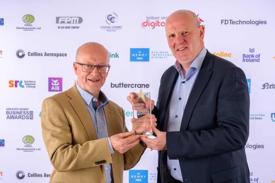  Brian Doran, SRC Chief Executive accepting his ‘Outstanding Contributor’ award at the Greater Newry Area Awards from Peter Murray, Centre Manager of Buttercrane.