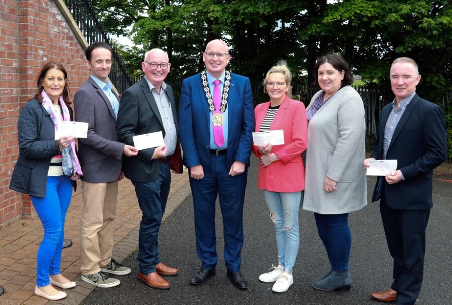 Newry, Mourne and Down District Council Chairperson, Cllr Michael Savage presents his four chosen charities each with a £5,500 cheque made up from proceeds from his successful Charity Ball in February. Included from left:  Marianne McCaul, Simon Community; Pat McGreevy and Darran McQuoid, Sucide Down to Zero; Chairman Cllr Michael Savage; Elizabeth Doherty and Margaret Kennefick, St Vincent de Paul and Damien Hillen, Southern Area Hospice.