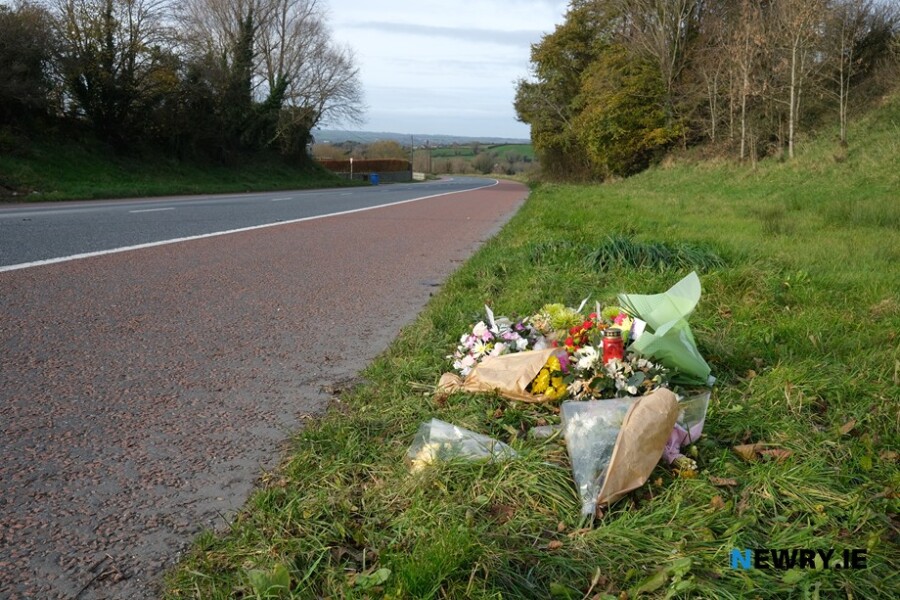 Flowers placed at the scene where the collision which claimed the lives of three people took place.