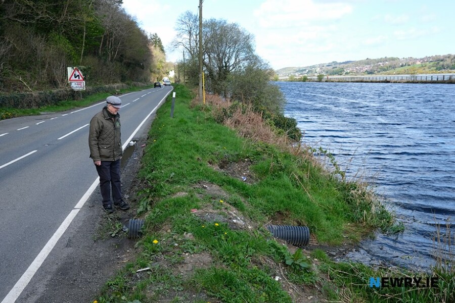 Oliver McGauley at one of the many pipes put through the bank of Newry Ship Canal. Photograph: Columba O'Hare/ Newry.ie 