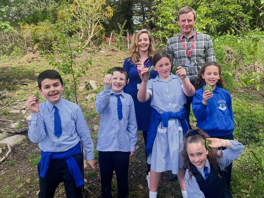 Justin McNulty MLA and Doire Finn with pupils from St Clare's Abbey PS.