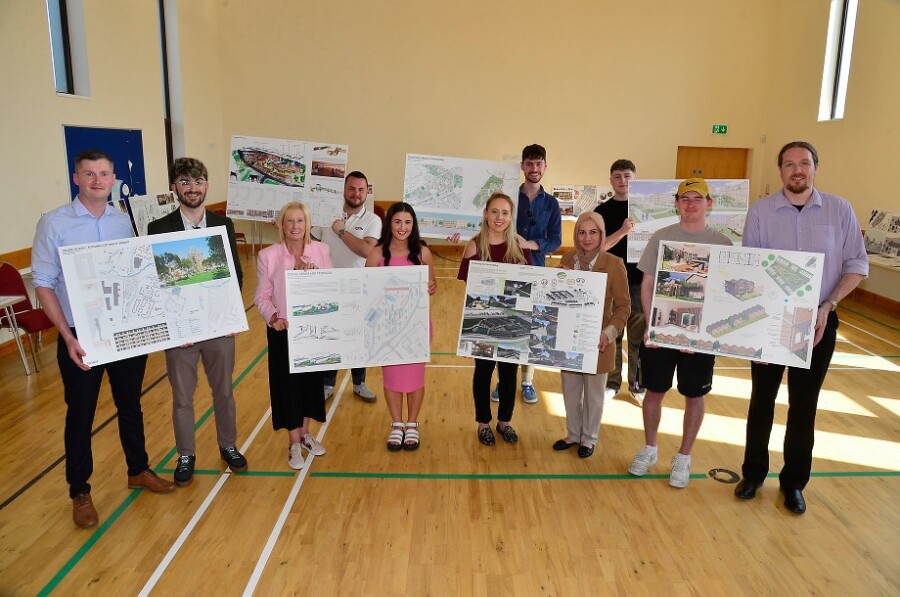 Students and Housing Executive staff proudly present some of the shortlisted designs at the public exhibition in St Hilda’s Hall, Seymour Hill, Dunmurry. Photograph: Housing Executive