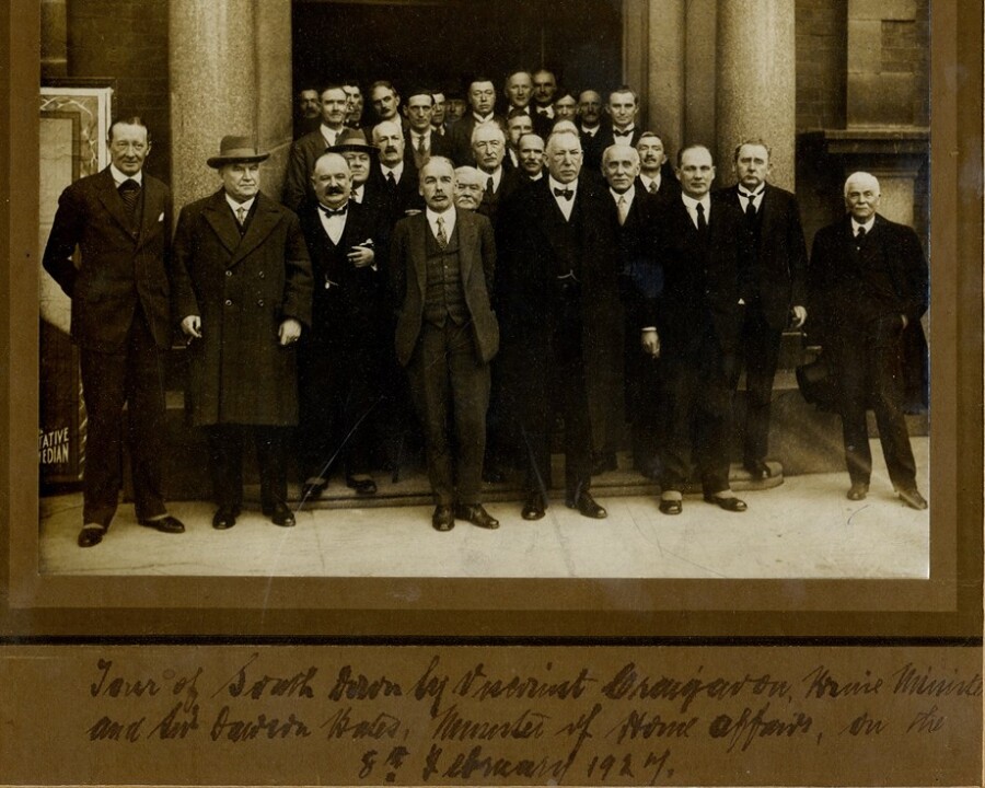 Photograph taken outside Newry Town Hall on 8th February 1927, marking the visit of James Craig, Prime Minister of Northern Ireland, to meet with members of Newry Urban District Council and other local public bodies. James Craig, Viscount Craigavon, can be seen in the front row, third from right with Sir Dawson Bates, Minister of Home Affairs on his right and William Robinson, Chairman of the Council on his left. Newry and Mourne Museum Collection