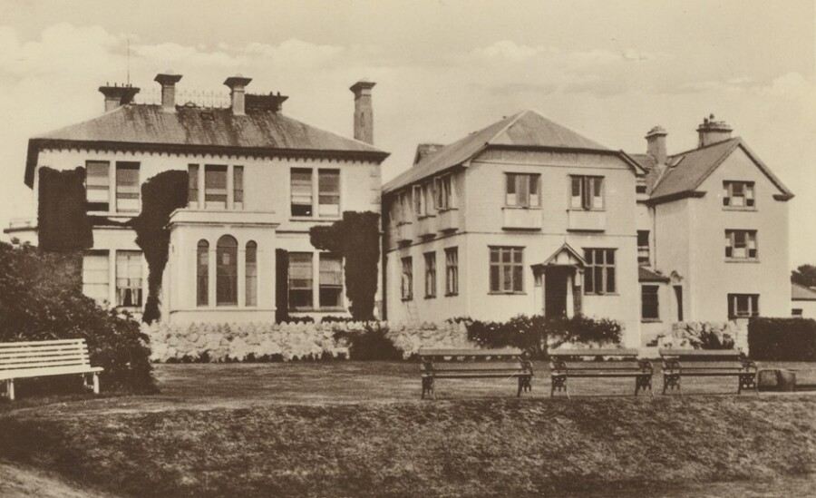 A Postcard showing Mourne Grange School in the 1920s. The original Drumindoney House can be seen on the left with the 1904 extension in the centre which contained a dining hall on the ground floor and dormitories above. Further classrooms were in the building on the right. Newry and Mourne Museum Collection
