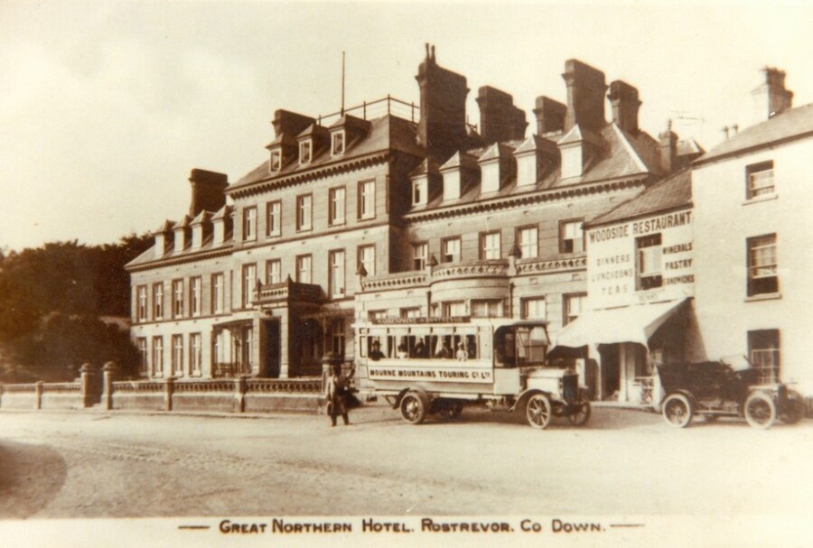 The Great Northern Hotel pictured in the early 20th century with a local touring bus in the foreground. The Woodside Restaurant can also be seen adjacent to the hotel. Newry and Mourne Museum Collection.