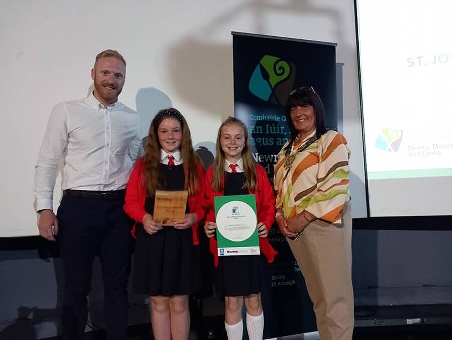 Eamonn Magee, Freya Farrell and Olivia Gray from St. Joseph’s Convent Primary School celebrate their Eco-School of the Year prize with Newry, Mourne and Down District Council Chairperson, Councillor Valerie Harte