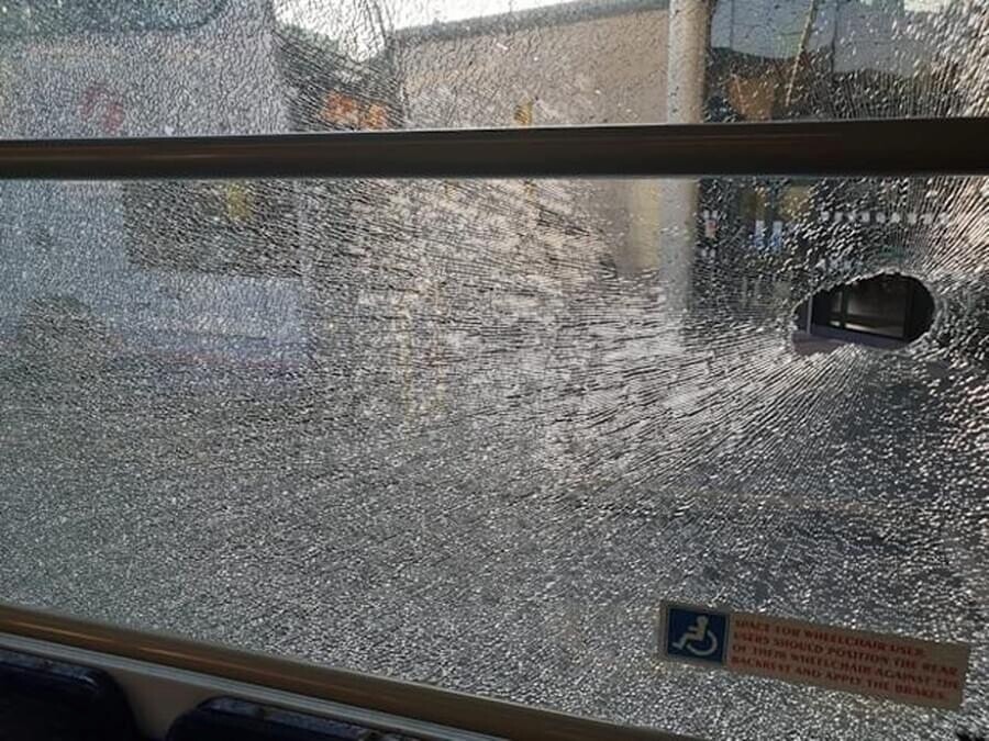 The smashed window on the bus