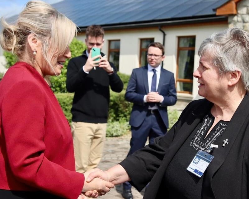 First Minister Michelle O Neill is welcomed by Cuan Mhuire Newry Head of House Sr Sheila Cronin 