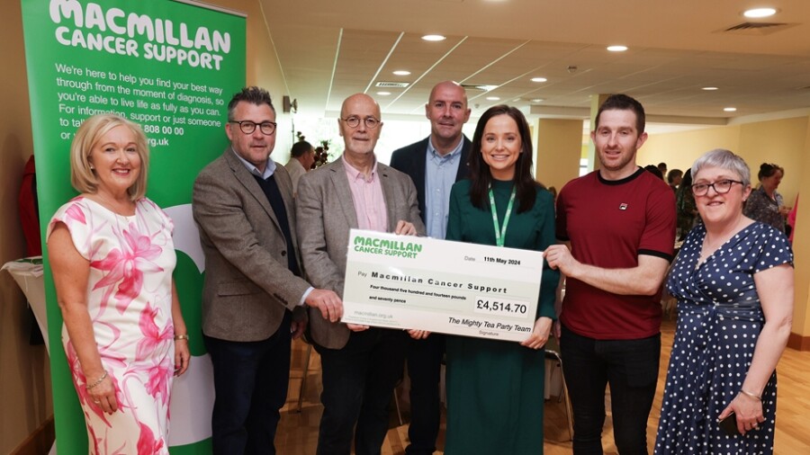 Pictured presenting a cheque for £4,514.70 to Macmillan at the Mighty Tea Party in Newry are from left:  Kathleen O'Hare, event organiser; Darren Swift, SiteTech, sponsor; Tyrone Allard OHMG Construction, sponsor; Raymond Harkin, Murdock Builders Merchants,sponsor; Emma Bannon, Macmillan Cancer Support; Marty Bell, KDM Hire, sponsor and Caroline Smith, event organiser. Photograph: Kelvin Boyes