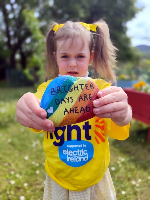 Aisling Smith, P1 pupil at St Malachy’s PS Camlough, displays one of the colourful ‘Positivity Stones’ that the pupils made ahead of the annual Darkness into Light event.